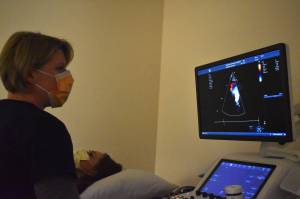 Clayton Franke / The Daily World
Jennifer Ferry, an echocardiographer at Providence Medical Groups vascular clinic in Aberdeen, demonstrates the clinics vascular ultrasound machine on Hillary Brodin, the clinics manager, on Feb. 23. Using sound waves, the machine can form images of blood flow and vein function in order to identify and assess disease.