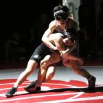 RYAN SPARKS | THE DAILY WORLD Grays Harbors Luis Barajas, left, wrestles with Washington States Kobe Bui during the 125-pound final at the NCWA Northwest Conference Championships on Saturday at Hoquiam High School.