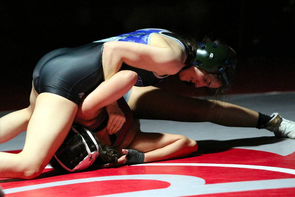 RYAN SPARKS | THE DAILY WORLD Grays Harbor Colleges Eden Lopez, left, works to pin Washington States Carlita Cardona-Arce during the 109-pound final of the NWAC Northwest Conference Championships on Saturday at Hoquiam High School.