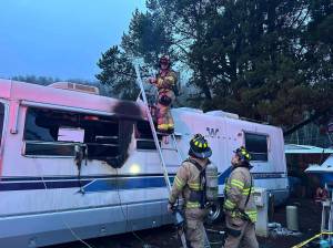 Hoquiam Fire Department
Firefighters investigate a Hoquiam trailer after a fire swept through, killing the resident.
