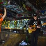 Matthew N. Wells / The Daily World
While its rare these days, musicians can be found playing underneath the North Aberdeen Bridge. Clinton Dogger Mullins is seen here jamming on his acoustic guitar in front of Tyrell Rutledge back in late spring 2023. Mullins was live-streaming his performance, which was dubbed SAVE Kurts Bridge, Session #1. A guitar case with a smattering of $1 and $5 bills lay nearby Mullins. I had about 20 people come through here in the last hour, Mullins said excitedly.