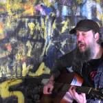 Tim Holehouse, an English musician who the late Kurt Cobain inspired to pick up the guitar, performed in front of a small audience underneath the Young Street Bridge  officially known as North Aberdeen Bridge. In front and to Holehouses right is the message RIP Kurdt, in reference to Cobains death. Behind Holehouses head is a painting of Cobains face. (Matthew N. Wells / The Daily World)