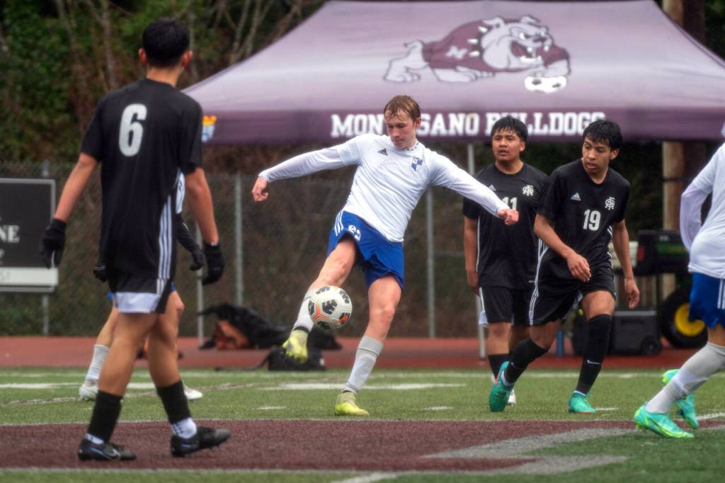 PHOTO BY FOREST WORGUM Elma senior forward Cason Seaberg, middle, gets a foot on the ball during a 3-1 loss to Royal on Saturday in Montesano.