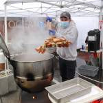 The Daily World file photo
Josh Debruler of the Port Angeles Dungeness Crab and Seafood Festival prepares a crab dinner at the 2022 clam festival in Ocean Shores. Crab dinners are available at this years festival, which takes place March, 15-17, 2024.
