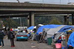 The Daily World file photo
People shelter with tarps and tents at an encampment on East River Street in Aberdeen last fall.