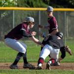 PHOTO BY FOREST WORGUM Montesano pitcher Skylar Bove attempts to tag out Teninos Austin Gonia (7) during the Bulldogs 10-6 loss on Tuesday at Vessey Field in Montesano.