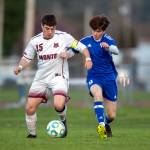 PHOTO BY FOREST WORGUM Montesano junior forward Felix Romero (15) dribbles while being defended by Elmas Matthew Wood during the Bulldogs 3-1 victory on Wednesday at Elma High School.
