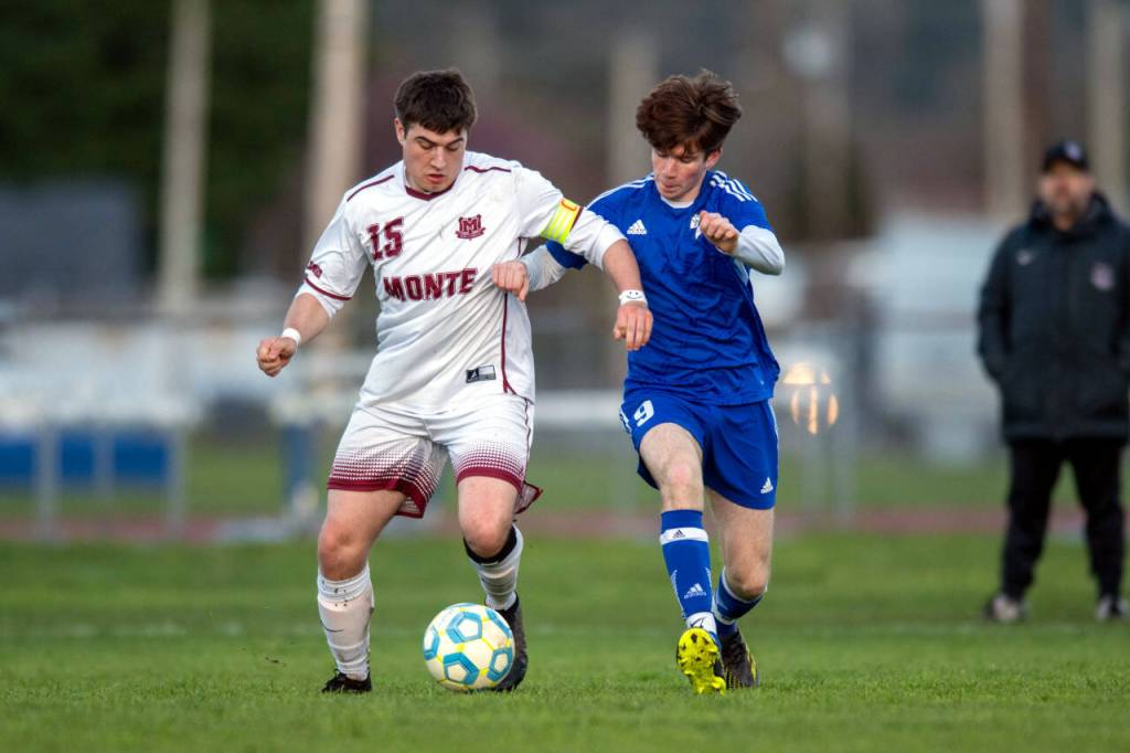 PHOTO BY FOREST WORGUM Montesano junior forward Felix Romero (15) dribbles while being defended by Elmas Matthew Wood during the Bulldogs 3-1 victory on Wednesday at Elma High School.