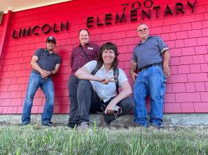Community Energy Labs
Tanya Barham, center, CEO of Community Energy Labs, poses with Hoquiam School District maintenance lead Matt Kemph and others outside Lincoln Elementary School in Hoquiam. The company recently tested an energy saving tool at the elementary school and completed a study of how to transition Grays Harbor schools to a more energy-efficient model.