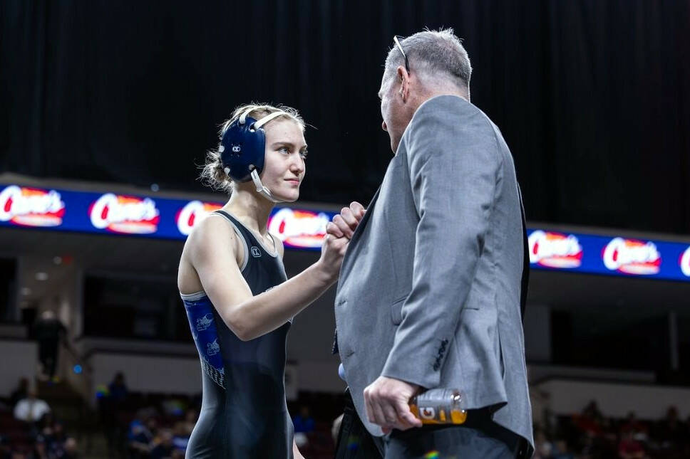 SUBMITTED PHOTO Grays Harbor College wrestler Alexandria Kauffman-Templeton, left, talks with head coach Kevin Pine during the NCWA National Championships in March in Louisiana. Pine resigned on Monday.