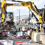 Clayton Franke / The Daily World
City of Aberdeen workers use heavy machinery April 3 to scoop up debris from the homeless encampment on River Street. The city has spent on average about $20,000 per month since the start of 2023 on trash cleanup in the downtown area.