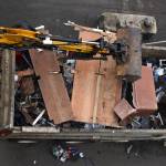 Clayton Franke / The Daily World
An excavator loads debris into a dump truck at the River Street homeless camp on April 3.