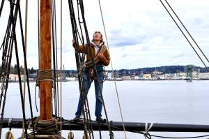 Bosun Kate Miller-Vickers helps ready the yards of the Lady Washington for the 2024 sailing season. (Michael S. Lockett / The Daily World)