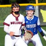 RYAN SPARKS | THE DAILY WORLD Montesano first baseman Grace Gooding, left, and Eatonvilles Zoe Burns look in toward home plate during the Bulldogs 12-0 victory on Tuesday in Montesano.