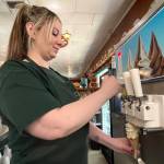 Matthew N. Wells / The Daily World
Andrea Plummer, whos worked at Clarks Restaurant for about 15 years, first experienced Clarks as a young customer. She said she was about knee-high. Plummer, seen serving up a homemade ice cream cone, is one of the friendly people who work at the restaurant with roots in the 1920s.