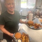 Matthew N. Wells / The Daily World
Deborah Hughes, holding two well-stacked bacon cheeseburgers fresh off the flat-top, is one of the friendly faces at Clarks Restaurant. Kathy Kalkwarf wanted to feature her staff, which is why shes not pictured. She knows she couldnt have operated such a successful business without her staff.
