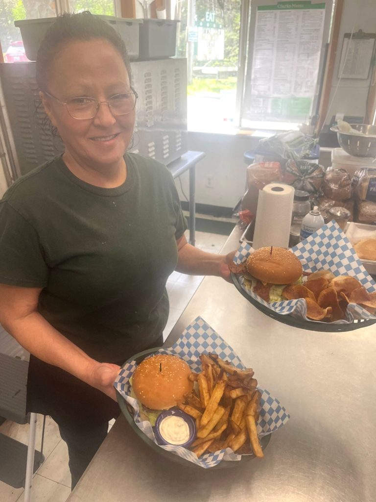 Matthew N. Wells / The Daily World
Deborah Hughes, holding two well-stacked bacon cheeseburgers fresh off the flat-top, is one of the friendly faces at Clarks Restaurant. Kathy Kalkwarf wanted to feature her staff, which is why shes not pictured. She knows she couldnt have operated such a successful business without her staff.