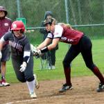 RYAN SPARKS | THE DAILY WORLD Raymond-South Bend third baseman Kassie Koski, right, tags out Hoquiams Macy Dhooghe trying to score during the Ravens 15-7 win on Thursday at John Gable Park in Hoquiam.