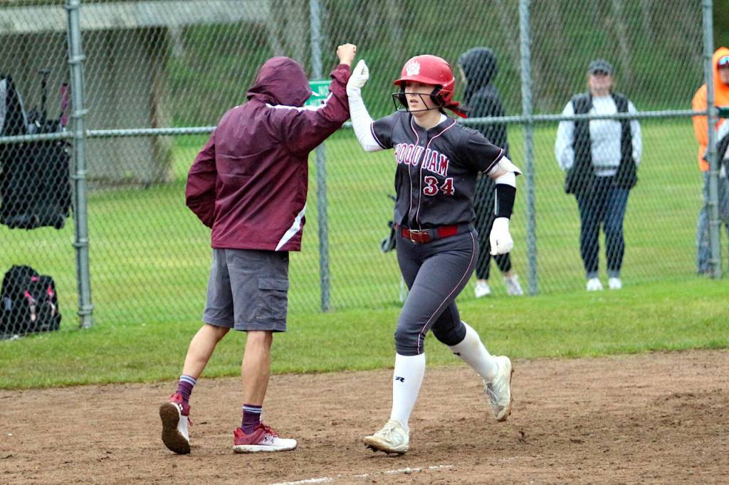 RYAN SPARKS | THE DAILY WORLD Hoquiam catcher Faith Prosch, right, gets a high-five from head coach John Matagora after hitting a home run during a 15-7 loss to Raymond-South Bend on Thursday in Hoquiam.
