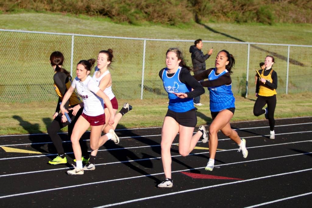 RYAN SPARKS | THE DAILY WORLD Elmas Eliza Sibbett, right, hands the baton off to Audreauna Kanios while Montesanos MaKenzie Eaton, left, receives the handoff from Sam Roundtree during the girls 4x100 relay at the Ray Ryan Memorial All-County Meet on Friday in Ocean Shores.
RYAN SPARKS | THE DAILY WORLD Elmas Eliza Sibbett, right, hands the baton off to Audreauna Kanios while Montesanos MaKenzie Eaton, left, receives the handoff from Sam Roundtree during the girls 4x100 relay at the Ray Ryan Memorial All-County Meet on Friday in Ocean Shores.