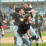 KODY CHRISTEN | THE CHRONICLE Montesanos Skylar Bove, right, and Jaxson Wilson, left, celebrate after taking the lead on Zach Timmons bases-clearing double in the first game of a double header on Saturday in Tenino.