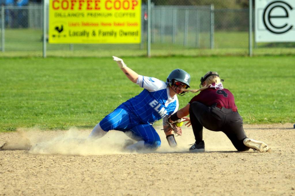 RYAN SPARKS | THE DAILY WORLD Elma senior Emmie Spencer, left, slides in ahead of the tag of Monte shortstop Addi Kersker during the Eagles 8-7 loss on Monday in Elma.