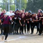 RYAN SPARKS | THE DAILY WORLD Montesano catcher Ali Parkin (3) is greeted by her teammates after hitting a three-run home run in the top of the seventh inning of an 8-7 win over Elma on Monday in Elma.