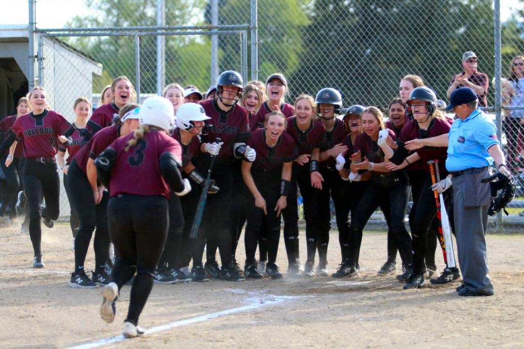 RYAN SPARKS | THE DAILY WORLD Montesano catcher Ali Parkin (3) is greeted by her teammates after hitting a three-run home run in the top of the seventh inning of an 8-7 win over Elma on Monday in Elma.