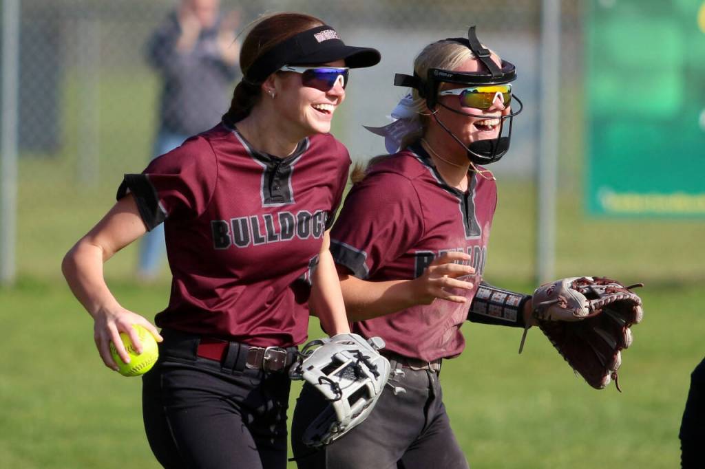 RYAN SPARKS | THE DAILY WORLD Montesano shortstop Addi Kersker, right, celebrates a leaping snow-cone catch by left fielder Liv Robinson, right, in the bottom of the fifth inning of the Bulldogs 8-7 win over Elma on Monday in Montesano.