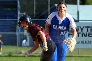 RYAN SPARKS | THE DAILY WORLD Montesanos Carsyn Wintrip, left, leads off first while Elma first baseman Callie Galligan looks toward home plate during the Bulldogs 8-7 win on Monday in Elma.