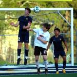 RYAN SPARKS | THE DAILY WORLD Aberdeen co-captain Isaiah Johnson (22) heads the ball against Centralias Miles Page as Bobcats defender Angel Espinosa (4) looks on during a game on Monday in Aberdeen.