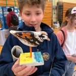 Julia Pinnix / U.S. Fish and Wildlife Service
14-year-old Dryden Quinton holds a model of a ruddy turnstone at the 2024 Grays Harbor Shorebird Festival.