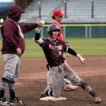 RYAN SPARKS | THE DAILY WORLD Montesano senior shortstop Bode Poler, right, gets a fist bump from head coach Mike Osgood after hitting a two-run triple in a 12-2 win over Castle Rock in a 1A District 4 Tournament game on Monday in Hoquiam.