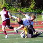 RYAN SPARKS | THE DAILY WORLD Columbia (White Salmon) defender Alexander Baldwin (9) collides with Bruins goal keeper Alfonso Serrato as Montesano forward Felix Romero looks to score during the Bulldogs 2-0 loss in a 1A District 4 semifinal game on Thursday in Montesano.