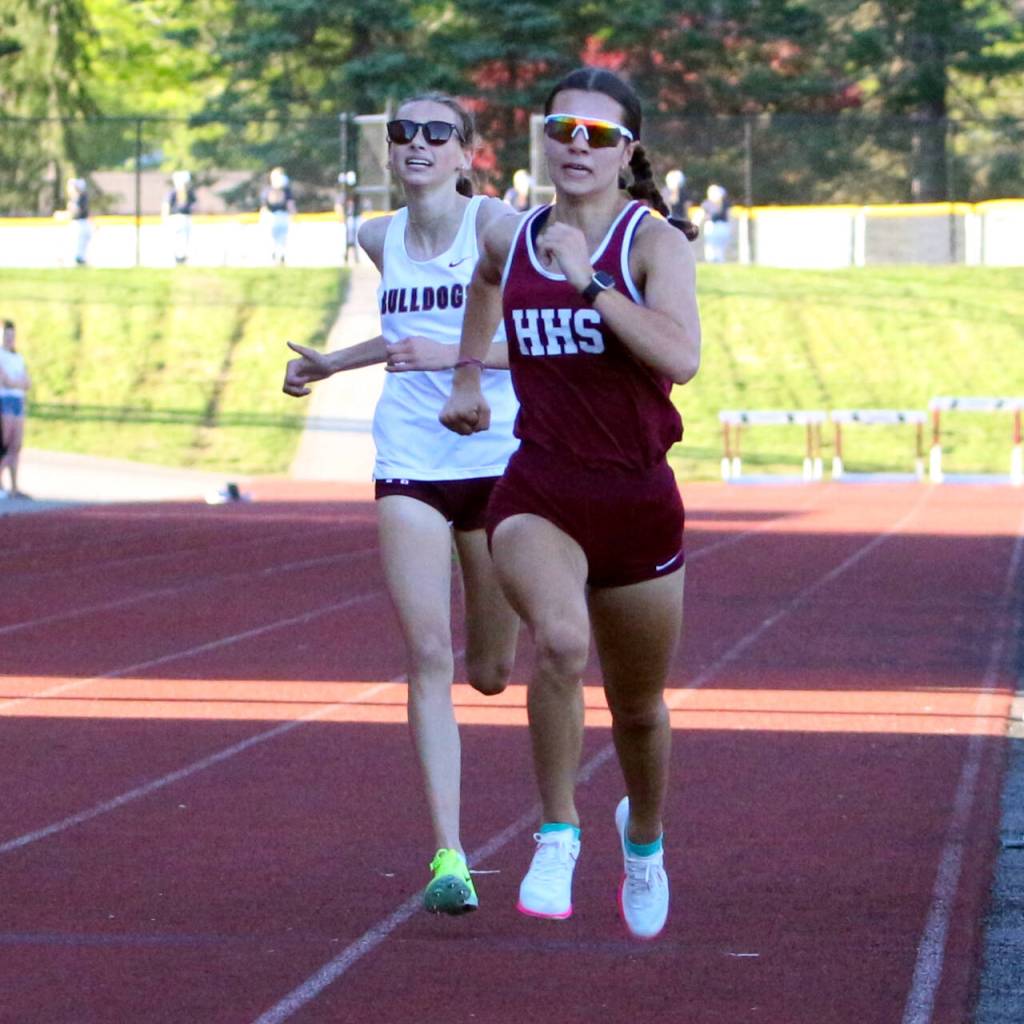 RYAN SPARKS | THE DAILY WORLD Hoquiam senior Jane Roloff (right) leads Montesano freshman Haley Schweppe down the back stretch of the girls 800-meter race at the 1A Evergreen Championships on Friday at Montesano High School.