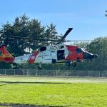 A Coast Guard MH-60 Jayhawk lands at the Ocosta School Districts football field before the student body on Tuesday. (Michael S. Lockett / The Daily World)