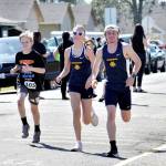 PHOTO BY RACHEL ROSE Members of the Aberdeen Bobcats track and field team run with a participant at the AJ West Fun Run on Friday in Aberdeen.
