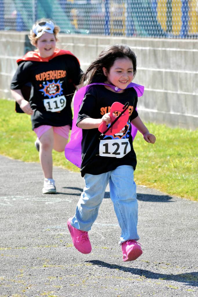 PHOTO BY RACHEL ROSE Two runners are all smiles as they participate in the AJ West Fun Run on Friday in Aberdeen.