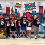 PHOTO BY RACHEL ROSE AJ West Fun Run participants pose for a superhero-themed photo as part of the event festivities on Friday in Aberdeen.