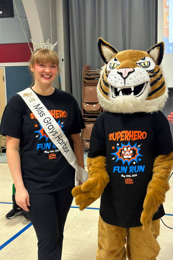 PHOTO BY RACHEL ROSE A.J. West alum and current Miss Grays Harbor Joslyn Williams and the schools mascot AJ pose for a photo at the AJ West Fun Run on Friday in Aberdeen.