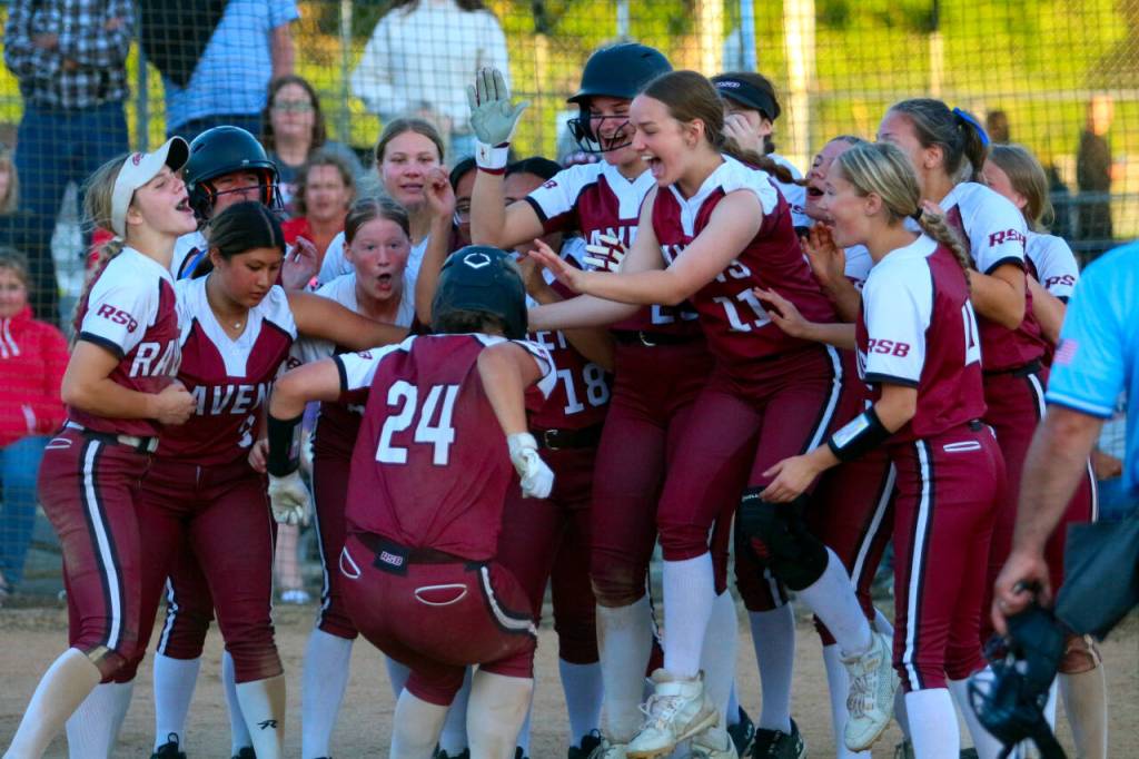 RYAN SPARKS | THE DAILY WORLD The Raymond-South Bend Ravens celebrate with catcher Ava Pine (24) after Pine hit a home run in a district-playoff game against Pe Ell-Willapa Valley on Wednesday in Centralia.