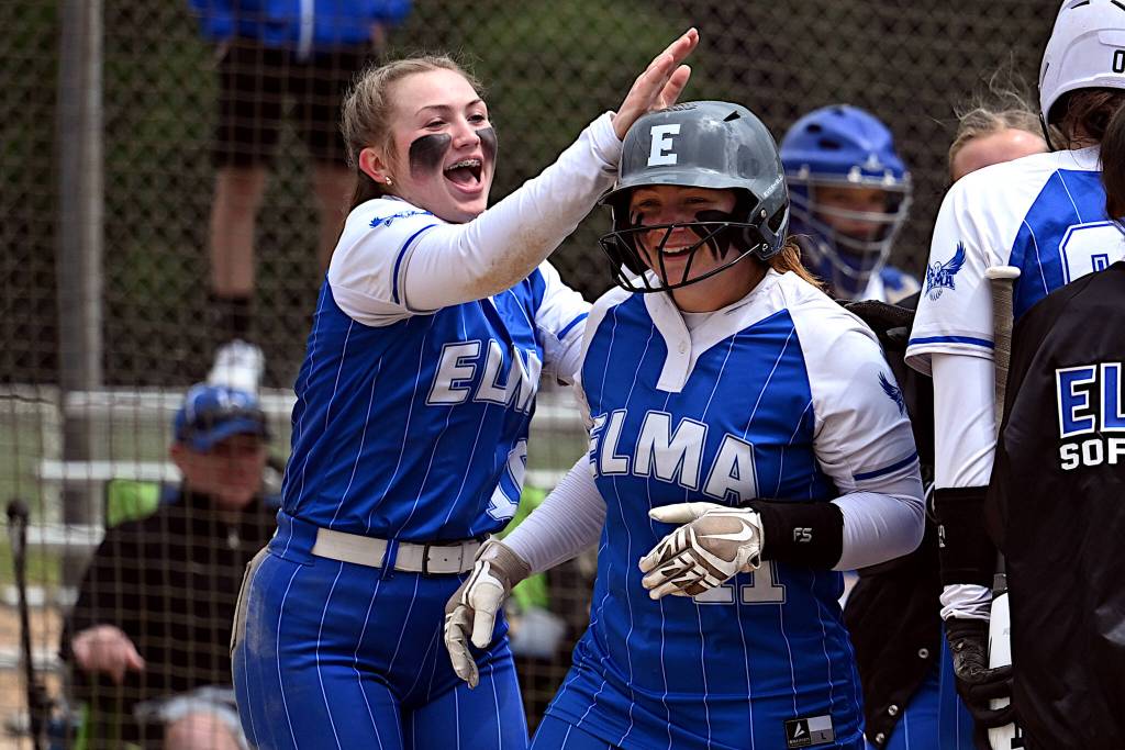 PHOTO BY CHRYSTAL WELD Elmas Lynsee Bednarik (left) congratulates teammate Emmie Spencer after Spencer hit a home run in a 24-10 victory over La Center in a 1A District 4 Tournament game on Saturday at Fort Borst Park in Centralia.