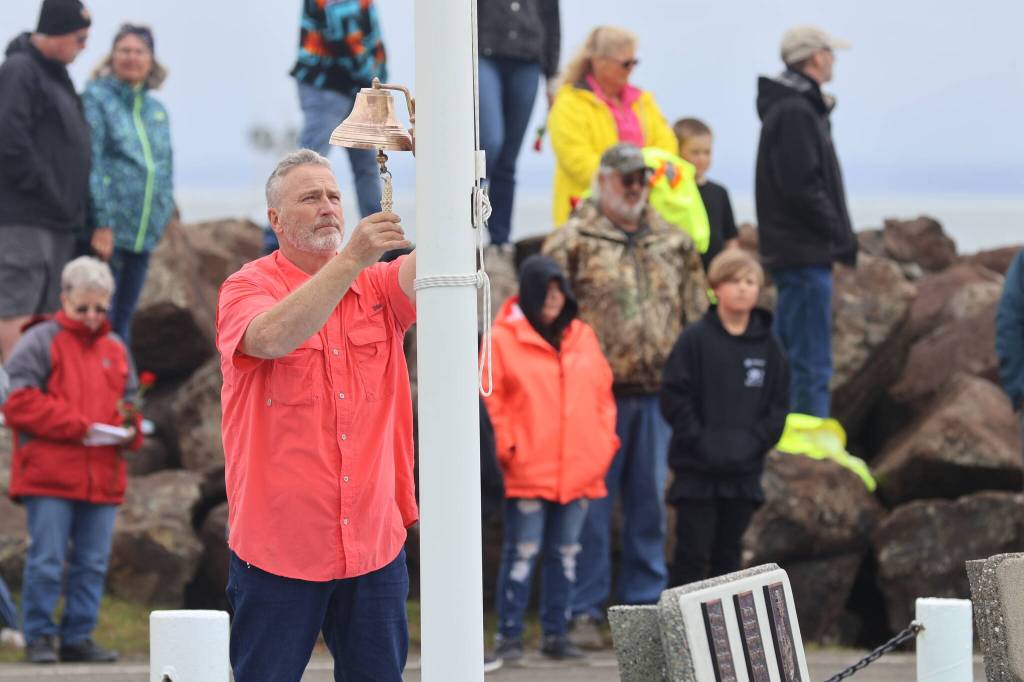 Michael S. Lockett / The Daily World
Longtime fisherman Greg Barnes rings the memorial bell as the names of those dead at sea are read during the Blessing of the Fleet.