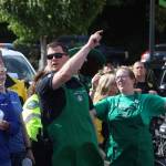 Sgt. Gary Sexton of the Aberdeen Police Department, pointing, and Jaki Meeks, store manager for the Aberdeen Starbucks, are co-organizers of the Badges and Brews event hosted by the coffee chain. (Michael S. Lockett / The Daily World)