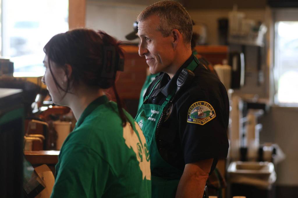 Emergency responders spent time on the line serving drinks during the Badges and Brews event hosted by the Aberdeen Starbucks. (Michael S. Lockett / The Daily World)