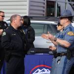 Chief Dale Green of the Aberdeen Police Department, left, talks to troopers from the Washington State Patrol during the Badges and Brews event hosted by the Aberdeen Starbucks. (Michael S. Lockett / The Daily World)