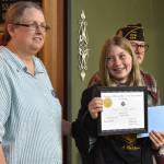 Matthew N. Wells / The Daily World
Lyla Wheeler, center, a fifth grader from North River School, won the VFW Red, White and Blue Scholarship Competitions first place prize of $150 in cash and a wood plaque for her mastery of The Star Spangled Banner. Barbara Dyer, president of VFW Post 224, helped Anthony Magri, post commander, present the award to Lyla on Tuesday night at American Legion Hall Post 5, in Aberdeen.