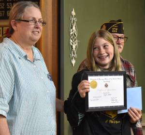Matthew N. Wells / The Daily World
Lyla Wheeler, center, a fifth grader from North River School, won the VFW Red, White and Blue Scholarship Competitions first place prize of $150 in cash and a wood plaque for her mastery of The Star Spangled Banner. Barbara Dyer, president of VFW Post 224, helped Anthony Magri, post commander, present the award to Lyla on Tuesday night at American Legion Hall Post 5, in Aberdeen.