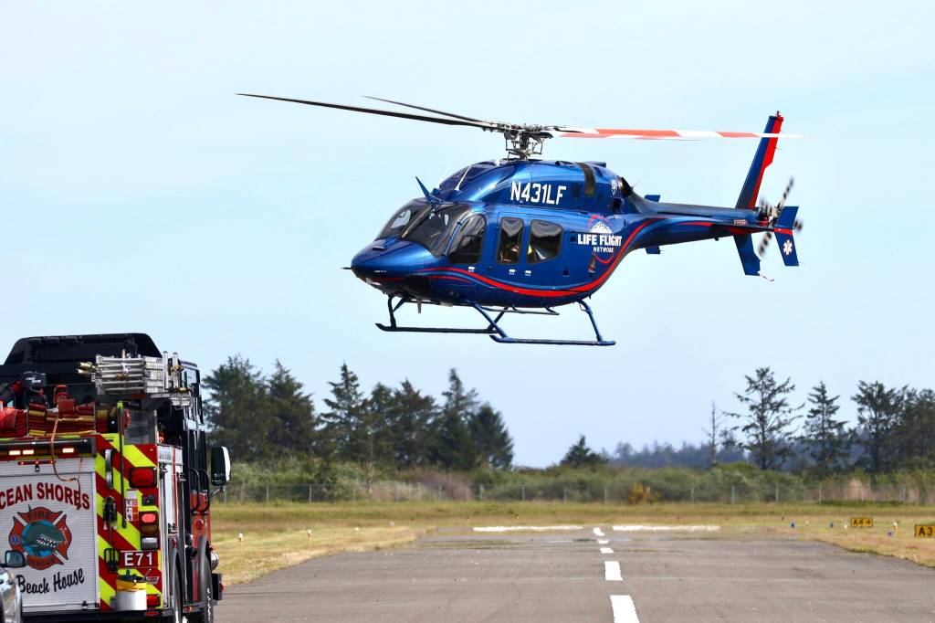A Life Flight Network helicopter takes off with a casualty following a plane crash at Ocean Shores Municipal Airport on Saturday. (Michael S. Lockett / The Daily World)