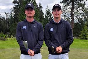 SUBMITTED PHOTO 
Grays Harbor College golfers Cole (left) and Brett Wasson pose for a photo during a NWAC League Match in April at Port Orchard. The college decided to suspend the mens golf and mens wrestling programs on Monday.